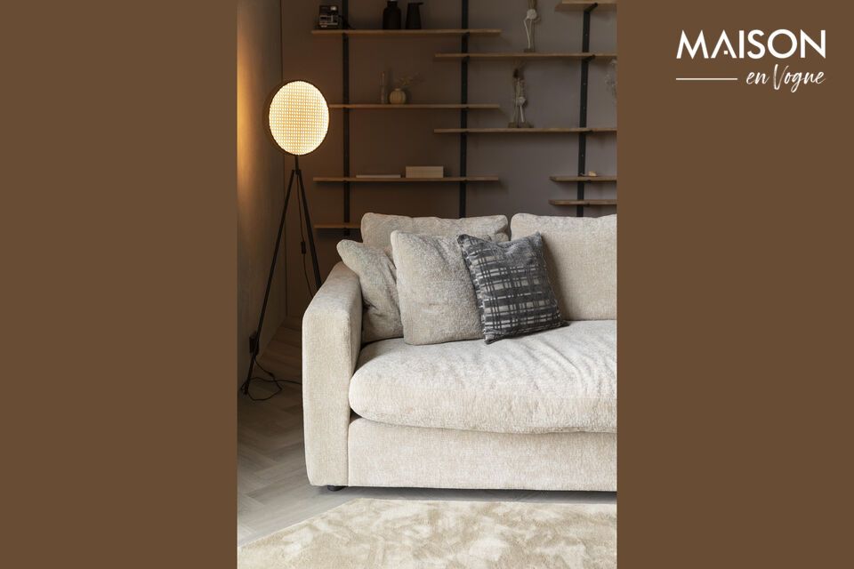 The sofa\'s organic shapes and abundant cushions evoke the softness of clouds
