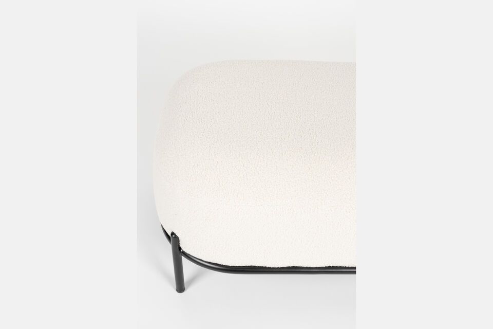 This footrest is upholstered in a soft beige fabric