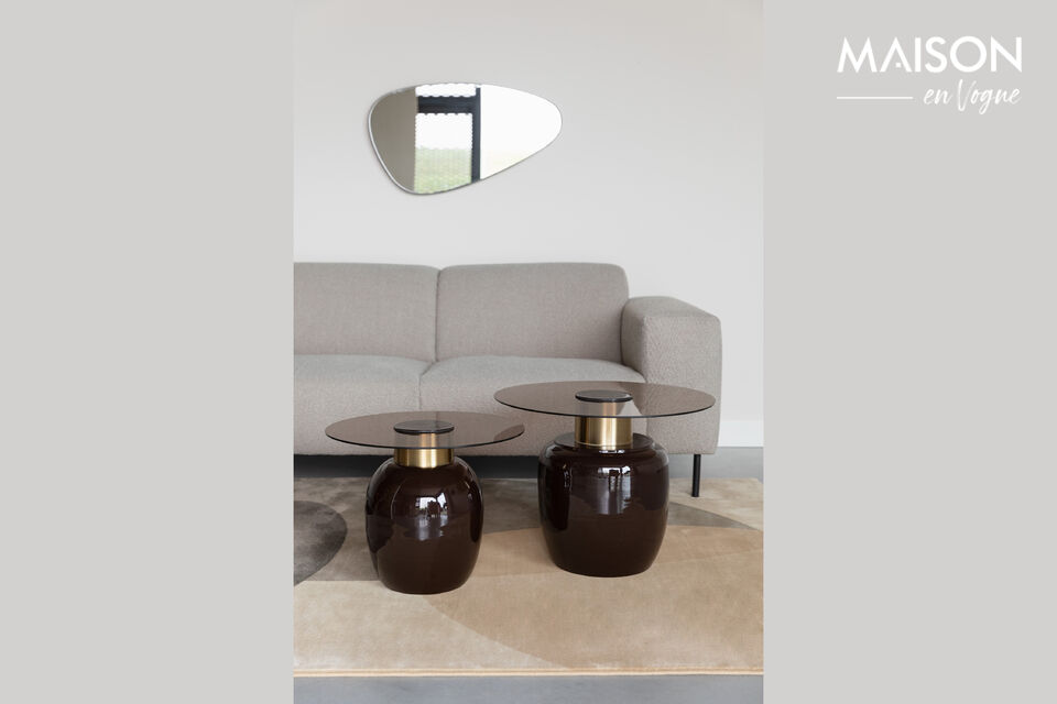 The Mohra side table is crafted with an enamel base and topped with smoked glass