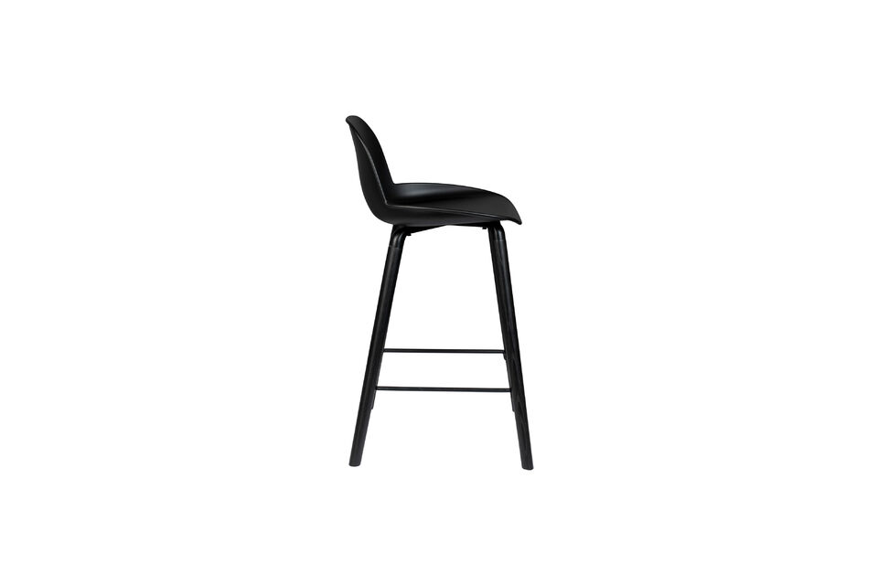 This modern design shell chair immediately stands out due to its all-black design