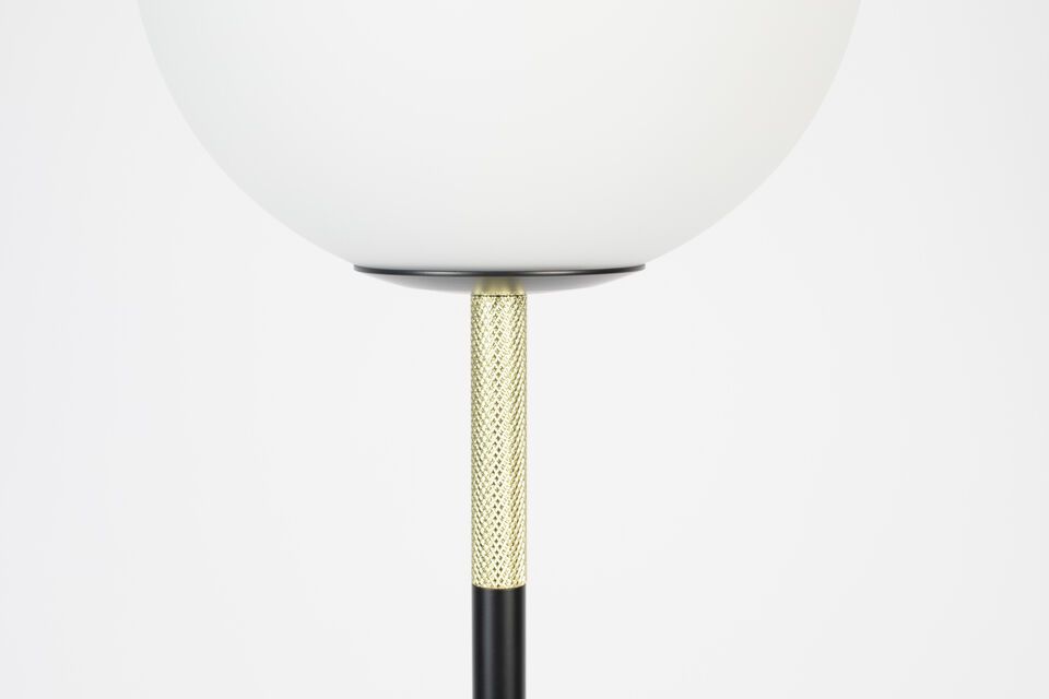 The black marble base and embossed brass details complete its refined look