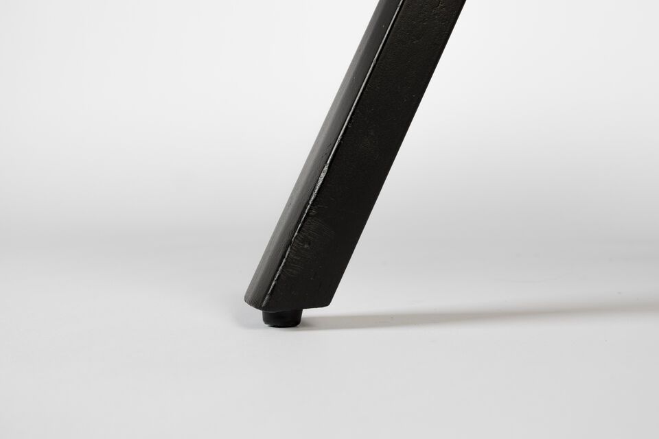 A deep black color and the rich texture of teak wood combine to create a piece of furniture that is