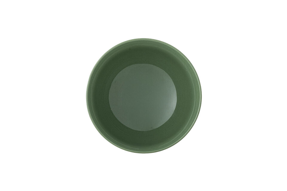 The soft beige exterior contrasts with a deep green interior and base