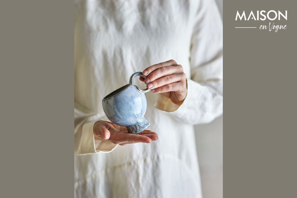 The Cup has a raised foot and a round handle