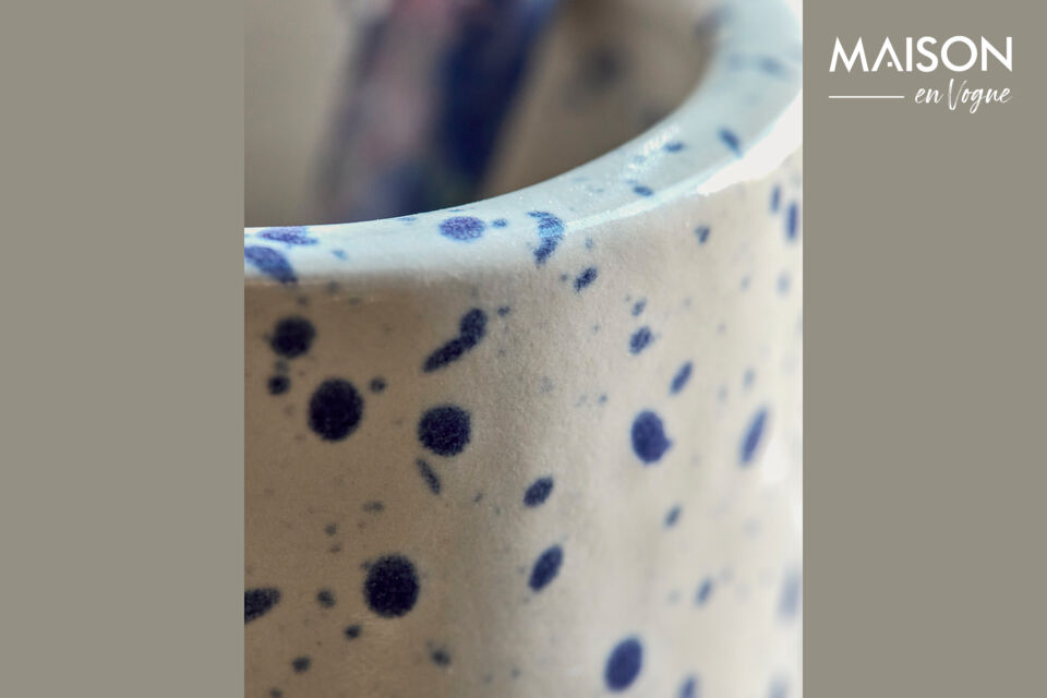 Its off-white base adorned with a playful blue splash pattern makes it a decorative yet practical