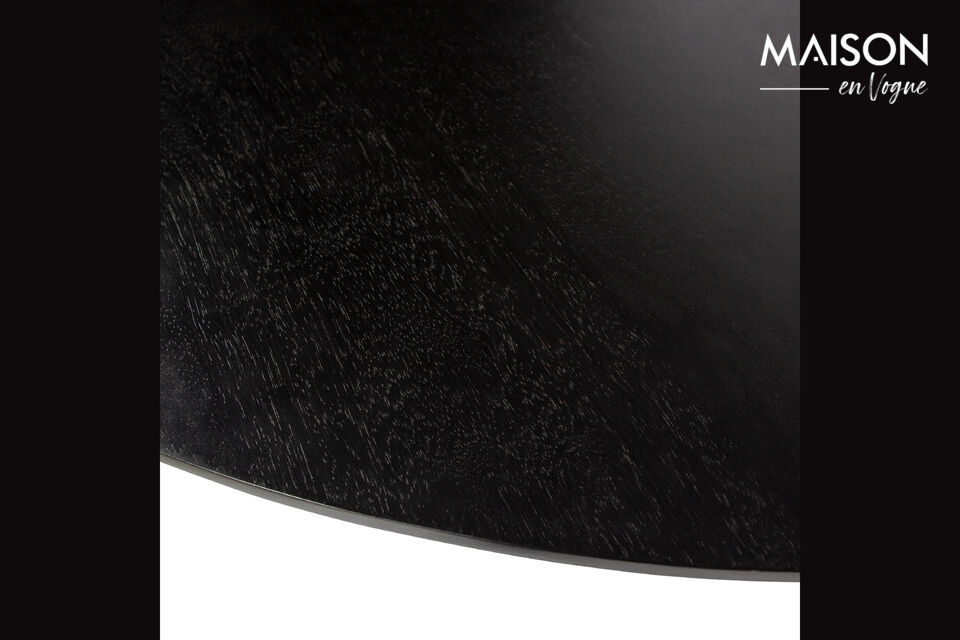 The dining table is crafted from mango wood with a deep black finish