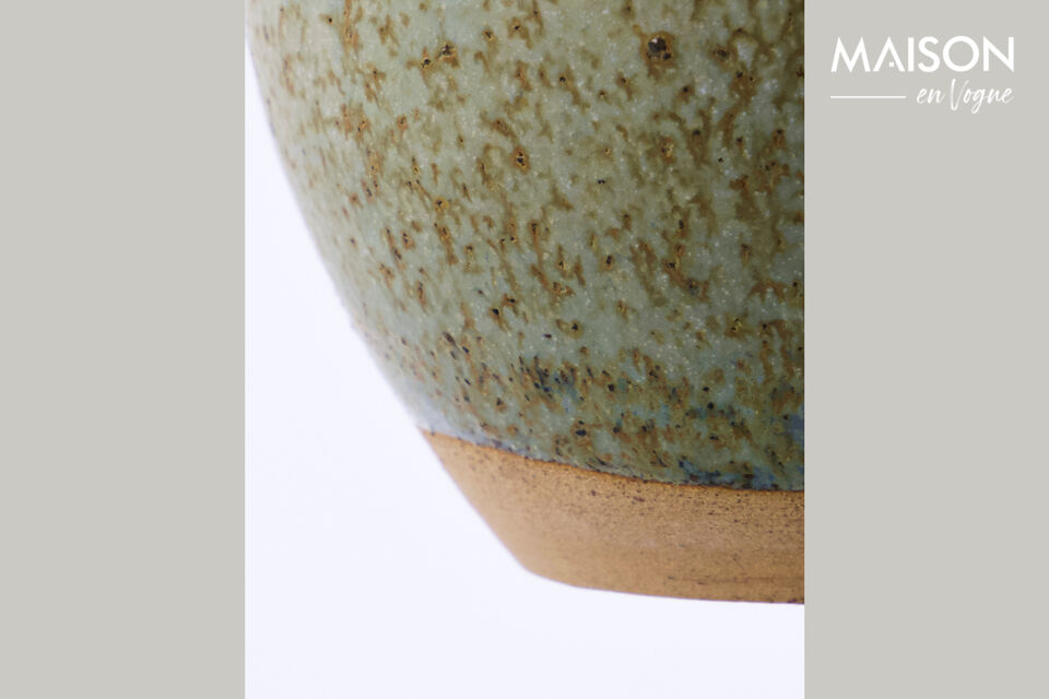 This handmade ceramic vase in warm grey tones is a delightful addition to your home decor