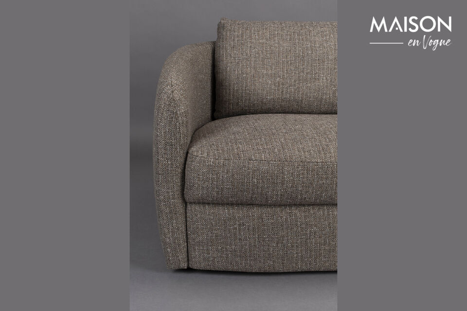 The furniture is richly upholstered in coarsely woven fabric and features rounded shapes