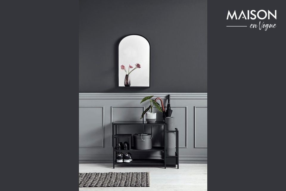 Discover this black iron shoe rack overhung by an aesthetic glass counter