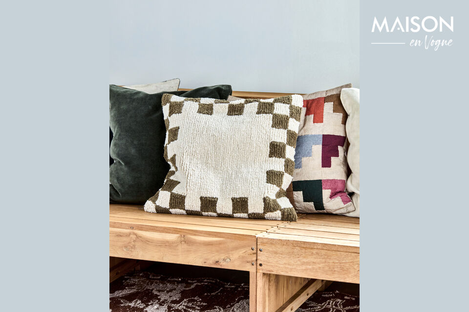 A cushion cover with a striking green and off-white chessboard pattern brings playful detail and
