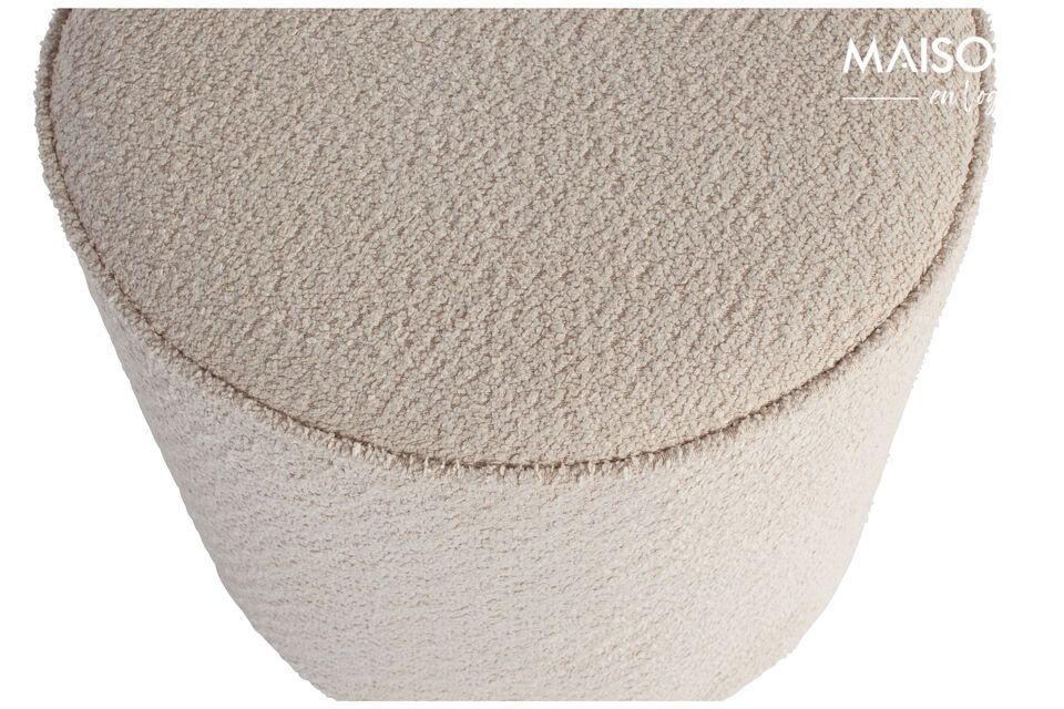 Le pouf rond effet peau de mouton de couleur crème est issu de la collection du label de design