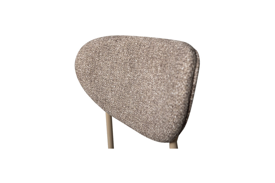 La silla de comedor está tapizada con una tela tejida y cuenta con una base de metal delgada en un