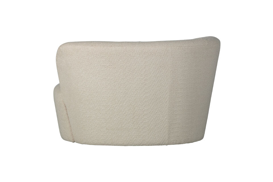 The bench is upholstered in soft boucle in a cream color