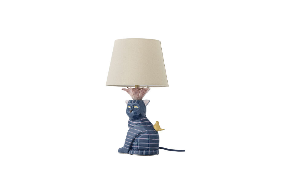 A beige linen shade rests on a rose-like detail