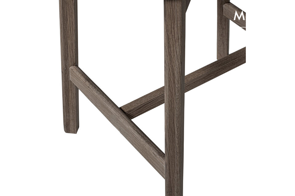 La base avec des veinures visibles et l\'assise rembourrée forment ensemble un tabouret de bar qui