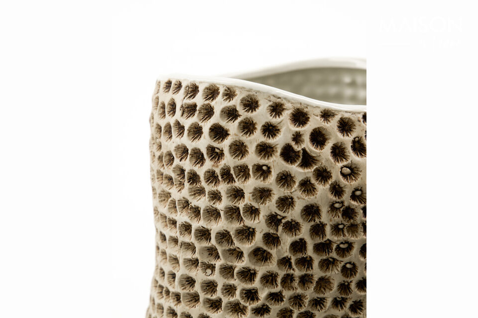 This beige stoneware vase showcases an organic form and intricate texture